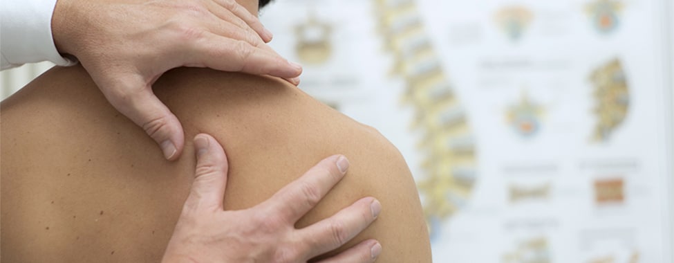 Man Meeting with Chiropractor for Alternative Pain Relief