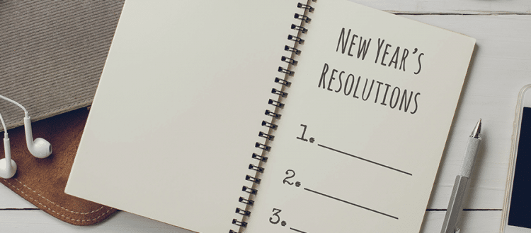 Open notebook with a page labeled "new year's resolutions" and a blank numbered list.