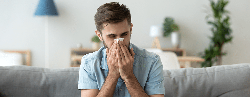 Man Sneezing Due to Sickness