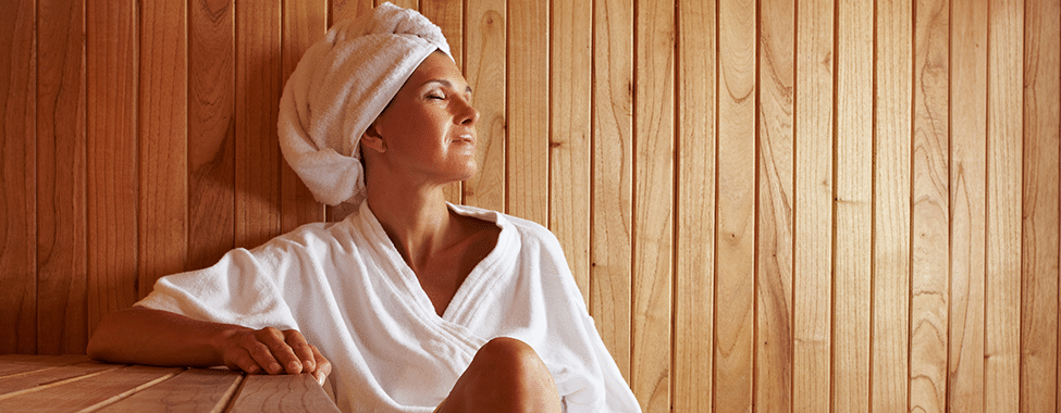 Woman Sitting in Sauna to Boost Immune System Naturally