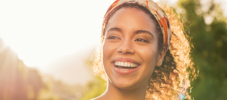 Woman smiling in warm sunlight