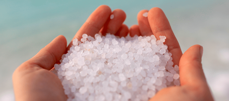 Person with both hands filled with salt crystals