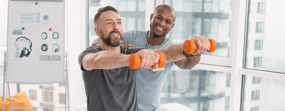 Physiotherapist helping a man with movement techniques