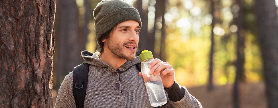 Man drinking water to stay hydrated in winter