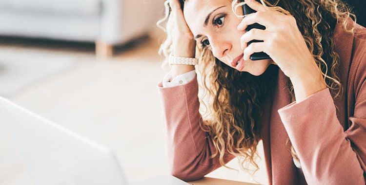 Stressed woman on the phone feeling burnout