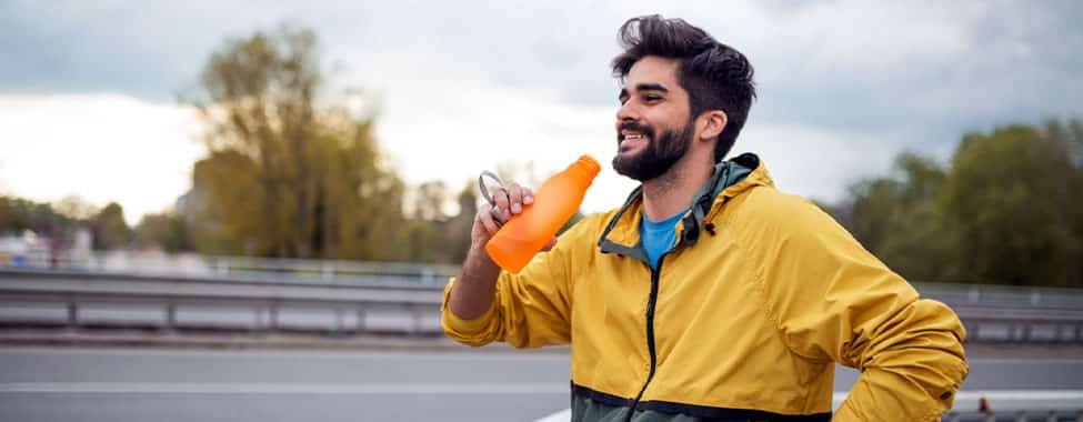 Man drinking water to help body detox