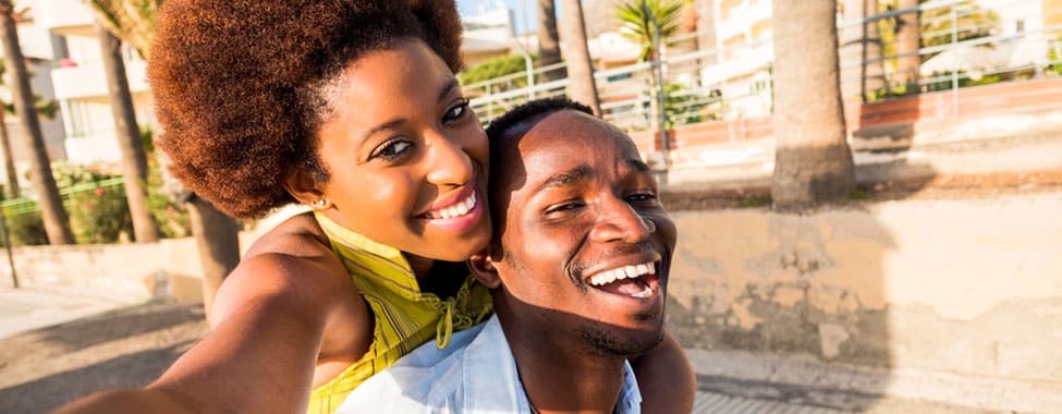 Happy couple smiling at the camera for a selfie