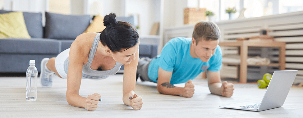 Couple Working Out at Home for Sore Muscle Prevention