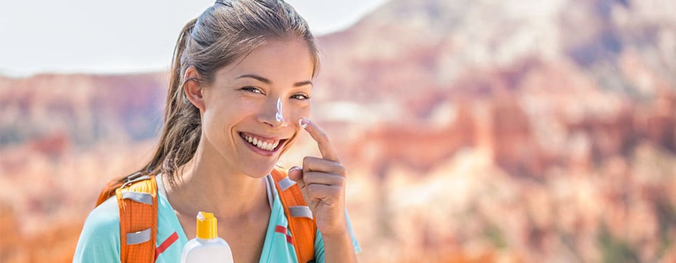 Woman Applying Sunscreen to Protect from Sun