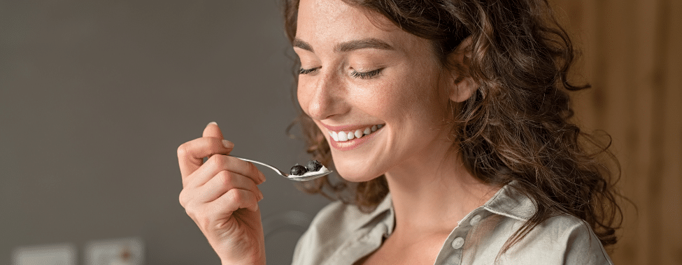 Woman Eating Yogurt and Blueberries for Immune Support