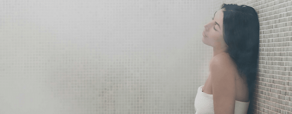 Woman Using Steam Room for Health Benefits